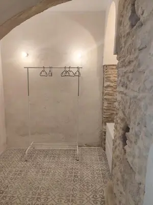 a bathroom with a shower in a stone wall at Maktub Medina in Medina Sidonia