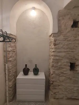 a room with two vases on a dresser next to a wall at Maktub Medina in Medina Sidonia