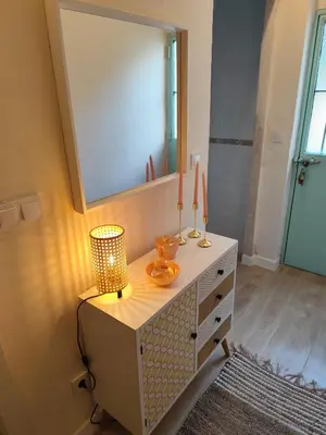 a bathroom with a mirror and a dresser with a lamp at Maktub Medina in Medina Sidonia