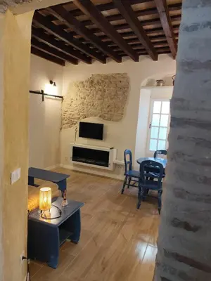 a living room with a tv and a table and chairs at Maktub Medina in Medina Sidonia
