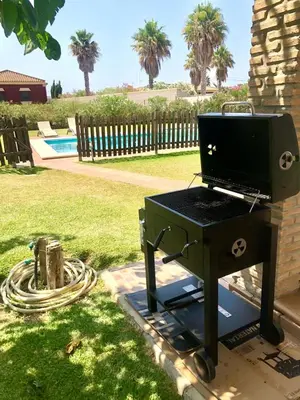 a bbq grill sitting next to a fire hydrant at Lazzy House in Hozanejos