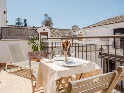 a table and chairs sitting on a balcony at Sibs Sanlucar Fariñas 11-15 - Historical building in Sanlúcar de Barrameda