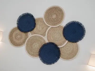 a group of straw hats hanging on a wall at Sibs Sanlucar Fariñas 11-15 - Historical building in Sanlúcar de Barrameda
