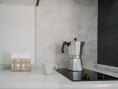 a coffee maker and a cup on a counter at Sibs Sanlucar Fariñas 11-15 - Historical building in Sanlúcar de Barrameda