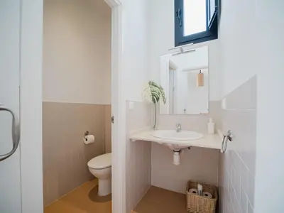 a bathroom with a sink and a toilet at Sibs Sanlucar Fariñas 11-15 - Historical building in Sanlúcar de Barrameda