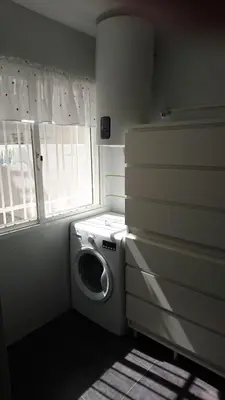 a washing machine in a room with a window at El Viñero, Apartamento con garaje in Cádiz