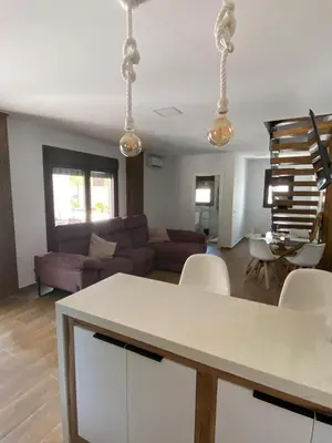 a living room with a couch and a table at La Cuesta in Chiclana de la Frontera