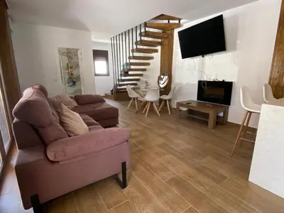 a living room with a couch and a tv at La Cuesta in Chiclana de la Frontera
