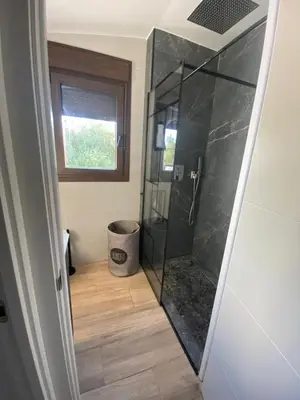 a bathroom with a shower with a glass door at La Cuesta in Chiclana de la Frontera