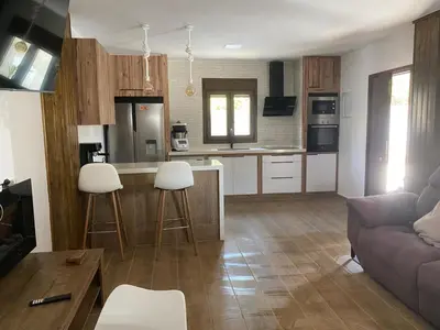 a kitchen and living room with a couch and a table at La Cuesta in Chiclana de la Frontera