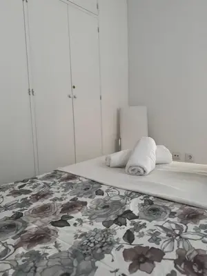 a bedroom with a bed with towels on it at Apartamento Los Pajaritos II in Jerez de la Frontera