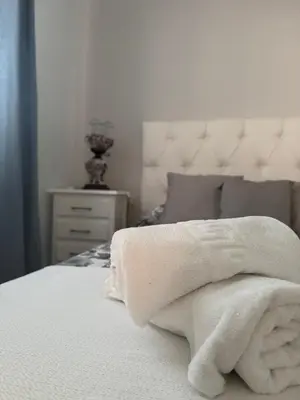 a bedroom with a bed with white towels on it at Apartamento Los Pajaritos II in Jerez de la Frontera
