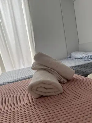 a pile of towels sitting on top of a bed at Apartamento Los Pajaritos II in Jerez de la Frontera