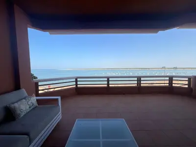 a living room with a couch and a view of the ocean at Mirador de Sanlucar 2 in Sanlúcar de Barrameda