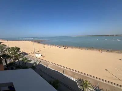 a view of a beach with people in the water at Mirador de Sanlucar 2 in Sanlúcar de Barrameda