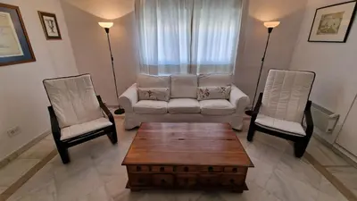 a living room with a couch and two chairs at Ático con espléndida terraza in Cádiz