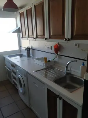 a kitchen with a sink and a washing machine at Ático con espléndida terraza in Cádiz