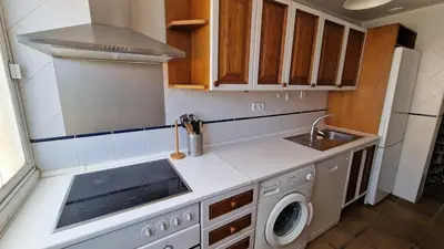 a kitchen with a sink and a washing machine at Ático con espléndida terraza in Cádiz