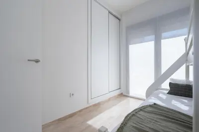 a bedroom with a bed and a large window at Casa Aura in Novo Sancti Petri