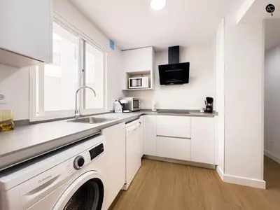 a white kitchen with a sink and a dishwasher at Apartamento La Caleta Grupo AC Gestion in Cádiz