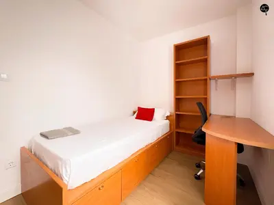 a small bedroom with a bed and a desk at Apartamento La Caleta Grupo AC Gestion in Cádiz