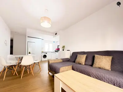 a living room with a couch and a table at Apartamento La Caleta Grupo AC Gestion in Cádiz