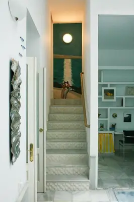 a staircase in a room with a painting on the wall at Caleta Club - Rooftop Villa, Cádiz in Cádiz