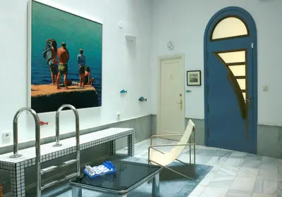 a bathroom with two sinks and a painting on the wall at Caleta Club - Rooftop Villa, Cádiz in Cádiz