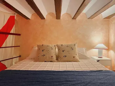a bedroom with a bed with pillows at Caleta Club - Rooftop Villa, Cádiz in Cádiz