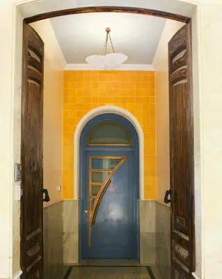 a blue door in a room with a yellow wall at Caleta Club - Rooftop Villa, Cádiz in Cádiz