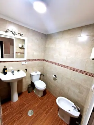 a bathroom with a white toilet and a sink at Casita ENTREARCOS in Arcos de la Frontera