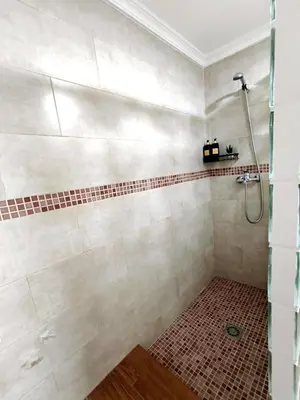 a bathroom with a shower with a tiled floor at Casita ENTREARCOS in Arcos de la Frontera