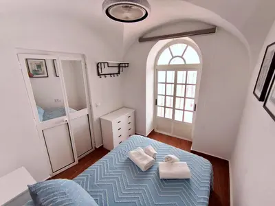 a bedroom with a bed with two towels on it at Casita ENTREARCOS in Arcos de la Frontera