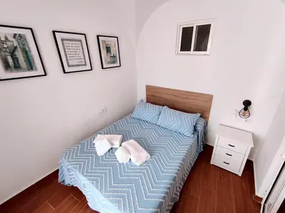 a bedroom with a bed with two towels on it at Casita ENTREARCOS in Arcos de la Frontera