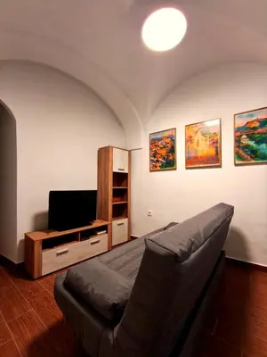 a living room with a couch and a tv at Casita ENTREARCOS in Arcos de la Frontera
