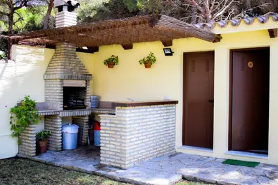 a house with a brick oven in the yard at Villa La Torre in Novo Sancti Petri