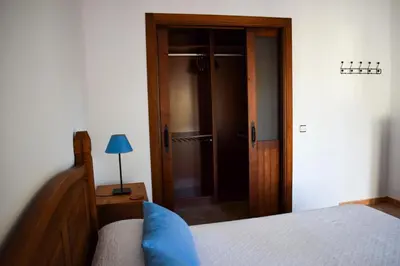 a bedroom with a bed and a wooden door at Villa La Torre in Novo Sancti Petri