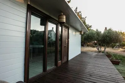 a porch with glass doors on a house at Casita Verbena Retreat in Novo Sancti Petri