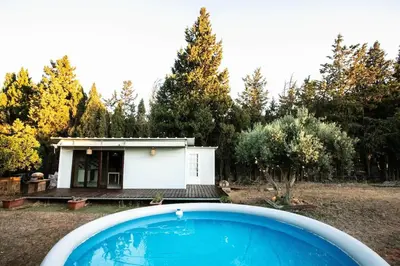 a swimming pool in front of a small house at Casita Verbena Retreat in Novo Sancti Petri