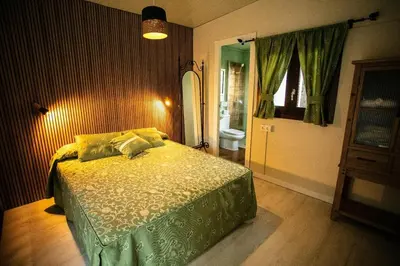 a bedroom with a bed and a bathroom at Casita Verbena Retreat in Novo Sancti Petri