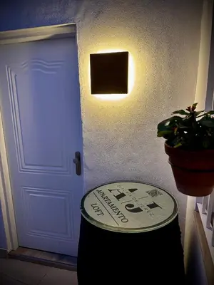 a door with a sign on it next to a plant at Loft Alegría de Jerez in Jerez de la Frontera