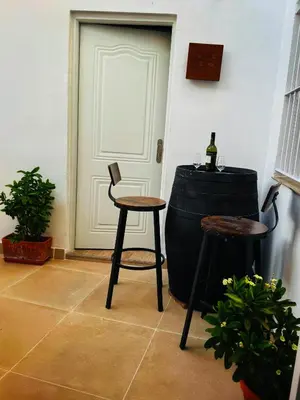 a room with a table and a chair next to a door at Loft Alegría de Jerez in Jerez de la Frontera