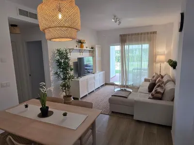a living room with a couch and a table at GINVA - Costa Ballena & Jardines de Majadales in Chipiona