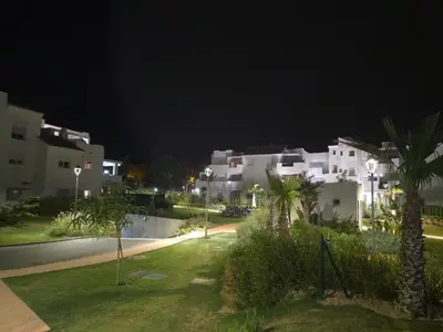a group of white houses at night with palm trees at GINVA - Costa Ballena & Jardines de Majadales in Chipiona