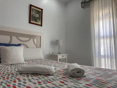 a bedroom with a bed with towels on it at La Torre de los Claustros - Ole Solutions in Jerez de la Frontera