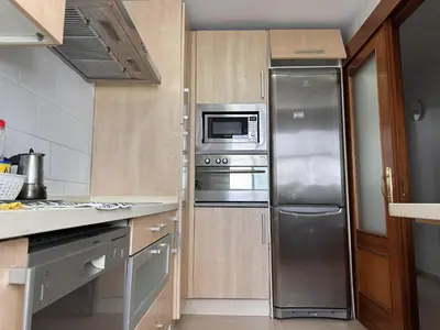 a kitchen with a stainless steel refrigerator and a microwave at La Torre de los Claustros - Ole Solutions in Jerez de la Frontera