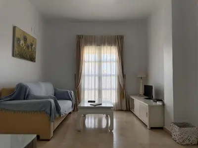 a living room with a couch and a window at La Torre de los Claustros - Ole Solutions in Jerez de la Frontera