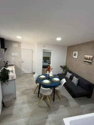 a living room with a table and a couch at Apartamento BF Jacuzzi Jerez in Jerez de la Frontera
