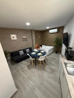 a living room with a table and a couch at Apartamento BF Jacuzzi Jerez in Jerez de la Frontera