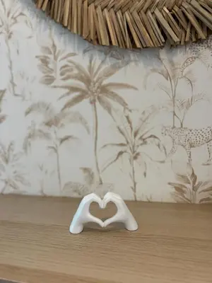 a white heart shaped object on a table with a wall at Apartamento Molino de Algarrobo in Arcos de la Frontera